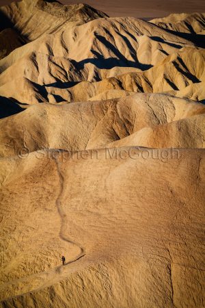Photographer in the Zabriskie Badlands, Death Valley National Park, California