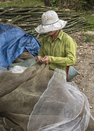 Vietnamese Fisherman – Repariing fishing nets